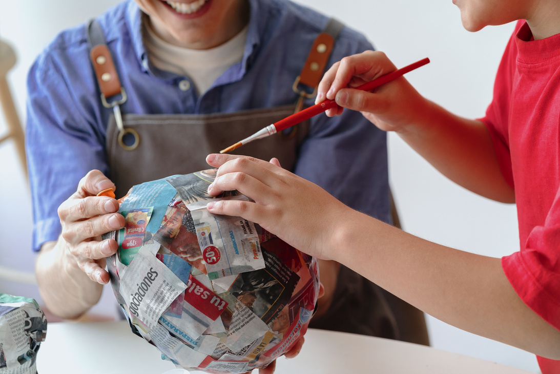 Boy and Man Making Paper Mache